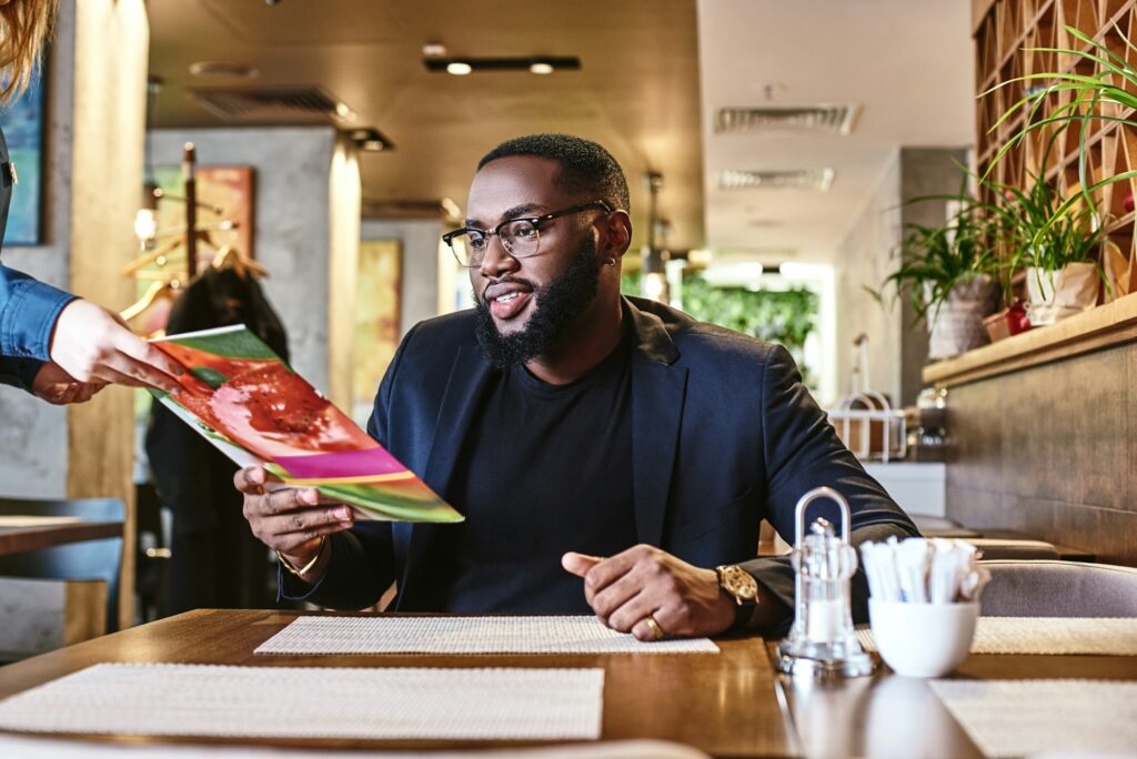 First we eat, then we do everything else. Young businessman came into the restaurant for lunch